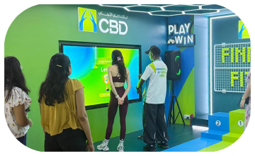 Interactive multi-level touch screen game rental at Dubai 30x30 event, showing guests engaged in a gamified fitness and financial literacy challenge.